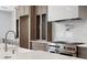 Gourmet kitchen showcasing a stainless steel range, a stylish backsplash, and custom cabinetry at 3406 W Alline Ave, Tampa, FL 33611