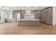 Spacious kitchen featuring custom cabinets, an oversized island, and hardwood flooring at 3406 W Alline Ave, Tampa, FL 33611