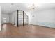 Bright, open living room with hardwood floors, modern lighting, and a unique wine storage display at 3406 W Alline Ave, Tampa, FL 33611