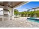 Outdoor kitchen with stainless steel appliances and a spa spilling into a pool at 3406 W Alline Ave, Tampa, FL 33611