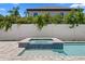 Backyard showcasing a modern pool with a raised spa and a well-maintained privacy fence at 3406 W Alline Ave, Tampa, FL 33611
