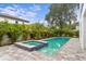Backyard pool and spa surrounded by lush tropical landscaping at 3406 W Alline Ave, Tampa, FL 33611