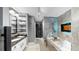 Stylish bathroom with double sinks, granite counters, custom shelving, and a luxurious bathtub with a TV screen at 345 Bayshore Blvd # Gp10, Tampa, FL 33606