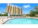 Swimming pool with surrounding lounge chairs and community building at 345 Bayshore Blvd # Gp10, Tampa, FL 33606