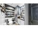 Stylish powder room featuring floating shelves, unique decor, and a granite countertop vanity at 345 Bayshore Blvd # Gp10, Tampa, FL 33606