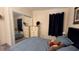 Comfortable bedroom with mirrored closet, dark blue accents, and natural light at 3829 Chah Dr, Zephyrhills, FL 33541