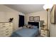 Inviting bedroom with a plush bed, decorative pillows, and a classic wooden dresser at 3829 Chah Dr, Zephyrhills, FL 33541