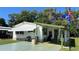 Charming single-story home featuring a well-maintained lawn, covered parking, and a welcoming front porch at 3829 Chah Dr, Zephyrhills, FL 33541