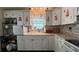 Well-equipped kitchen featuring white cabinetry and granite countertops, perfect for cooking and storage at 3829 Chah Dr, Zephyrhills, FL 33541