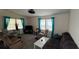 Spacious living room featuring ample seating and natural light, creating a welcoming and comfortable atmosphere at 3829 Chah Dr, Zephyrhills, FL 33541
