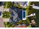 Stunning aerial view of a luxury home with a sleek pool and private dock at 389 Bayview Ne Dr, St Petersburg, FL 33704