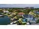 Aerial view of the waterfront property showing the pool, lush backyard, dock with boat lift, and ocean access at 389 Bayview Ne Dr, St Petersburg, FL 33704