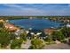 Aerial view of the beautiful white waterfront property with three-car garage and stunning water views at 389 Bayview Ne Dr, St Petersburg, FL 33704