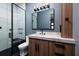 Contemporary bathroom boasts sleek marble countertops, black fixtures, and modern lighting at 389 Bayview Ne Dr, St Petersburg, FL 33704