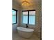 Chic bathroom featuring a free-standing tub and modern window and lighting fixtures at 389 Bayview Ne Dr, St Petersburg, FL 33704