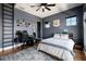 Cozy bedroom with hardwood floors, natural light, Route 66 decor, and a ceiling fan at 389 Bayview Ne Dr, St Petersburg, FL 33704