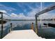 Waterfront property featuring private dock with boat lift, offering direct access to the water at 389 Bayview Ne Dr, St Petersburg, FL 33704