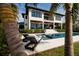 Gorgeous two-story home with a pool, spa, balcony, and outdoor seating area at 389 Bayview Ne Dr, St Petersburg, FL 33704