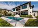 Luxury two-story home with manicured landscaping, a pool and an outdoor lounge area at 389 Bayview Ne Dr, St Petersburg, FL 33704