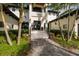 Elegant walkway leading to the front door of this beautifully landscaped property, accented by mature palm trees at 389 Bayview Ne Dr, St Petersburg, FL 33704