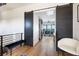 Hallway with hardwood floors, sliding barn doors, and scenic views beyond at 389 Bayview Ne Dr, St Petersburg, FL 33704