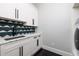 Bright laundry room features modern cabinets, sleek countertops, and herringbone floors at 389 Bayview Ne Dr, St Petersburg, FL 33704