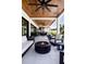 Relaxing outdoor living area featuring a fire pit, lounge seating, and wood paneled ceilings at 389 Bayview Ne Dr, St Petersburg, FL 33704