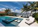 Beautiful backyard oasis with pool, spa, lounge chairs and tropical landscaping at 389 Bayview Ne Dr, St Petersburg, FL 33704
