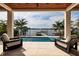 Covered outdoor seating area showing pool, spa and waterfront view at 389 Bayview Ne Dr, St Petersburg, FL 33704
