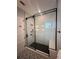 Contemporary bathroom shower features black hardware, glass doors, and herringbone tile at 389 Bayview Ne Dr, St Petersburg, FL 33704