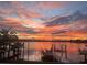Tranquil sunset view from waterfront dock with calm water reflecting vibrant colors at 389 Bayview Ne Dr, St Petersburg, FL 33704