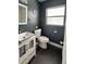 Stylish half bathroom featuring a modern vanity with a vessel sink, dark walls, and nautical decor for a sophisticated look at 428 45Th N Ave, St Petersburg, FL 33703