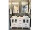 Elegant dual sink bathroom vanity with a white countertop, stylish mirrors, and modern fixtures at 428 45Th N Ave, St Petersburg, FL 33703
