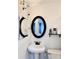 Well-lit bathroom featuring a pedestal sink, oval mirror, and fresh decor, providing a comfortable and functional space at 428 45Th N Ave, St Petersburg, FL 33703