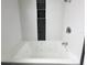 Inviting bathtub with a modern faucet, surrounded by white subway tiles, offering a clean and relaxing bathing experience at 428 45Th N Ave, St Petersburg, FL 33703