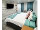 Bright bedroom with white and wood plank accent wall, comfy queen bed, and teal colored accents at 428 45Th N Ave, St Petersburg, FL 33703