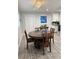 Dining area with new hardwood flooring, modern light fixture, and adjacent kitchen with white cabinets at 428 45Th N Ave, St Petersburg, FL 33703