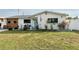 Charming single-story home featuring a well-kept front yard, decorative landscaping and blue trim at 428 45Th N Ave, St Petersburg, FL 33703