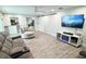 Modern living room featuring wood floors, a large TV, and an open layout at 428 45Th N Ave, St Petersburg, FL 33703