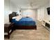Large main bedroom with wood-look tile flooring, ceiling fan and ensuite bath access at 428 45Th N Ave, St Petersburg, FL 33703