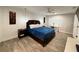 Light and bright main bedroom with wood-look tile flooring, ceiling fan and bedside tables at 428 45Th N Ave, St Petersburg, FL 33703