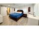 Spacious main bedroom with ceiling fan, ensuite bath, barn door, desk and wood-look tile flooring at 428 45Th N Ave, St Petersburg, FL 33703