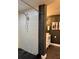 Shower with white tiled walls and a shower head with black river rock flooring at 428 45Th N Ave, St Petersburg, FL 33703