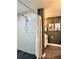 Shower with white tiled walls and a shower head with black river rock flooring at 428 45Th N Ave, St Petersburg, FL 33703