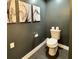 Modern half bath with dark gray walls and flooring featuring abstract art at 428 45Th N Ave, St Petersburg, FL 33703