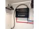 Tankless water heater unit installed with blue and red water lines in closet at 428 45Th N Ave, St Petersburg, FL 33703