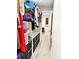 Spacious walk-in closet with custom shelving, and view to a bright room with tile flooring at 428 45Th N Ave, St Petersburg, FL 33703