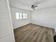 Light and airy bedroom with tile floor, ceiling fan and plantation shutters at 502 Palm Dr, Largo, FL 33770
