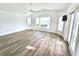 Bright and open living room with tile floor, water view bay window, and sliding door access at 502 Palm Dr, Largo, FL 33770