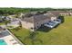 Aerial view showcasing a residential building and surrounding greenery with a community pool at 5022 Chipotle Ln, Wesley Chapel, FL 33544